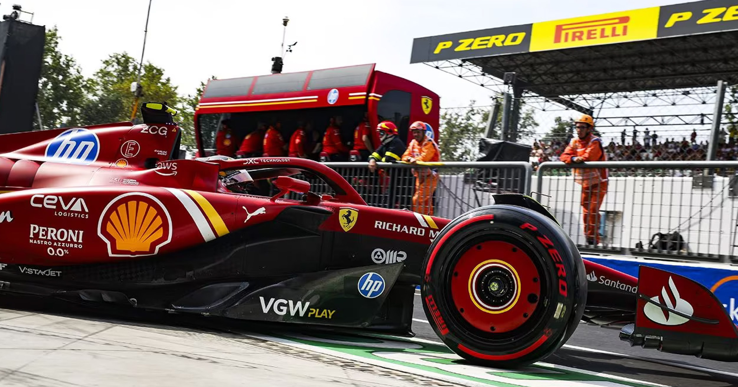 Ferrari Formula 1 car in the pit lane during the 2024 Azerbaijan Grand Prix, with the team preparing for a tire change at the Baku City Circuit.