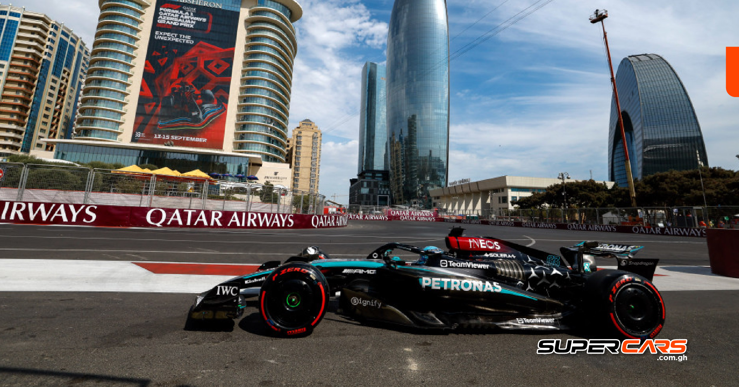 Mercedes Formula 1 car racing at the 2024 Azerbaijan Grand Prix, with Baku’s modern skyline in the background at the Baku City Circuit.