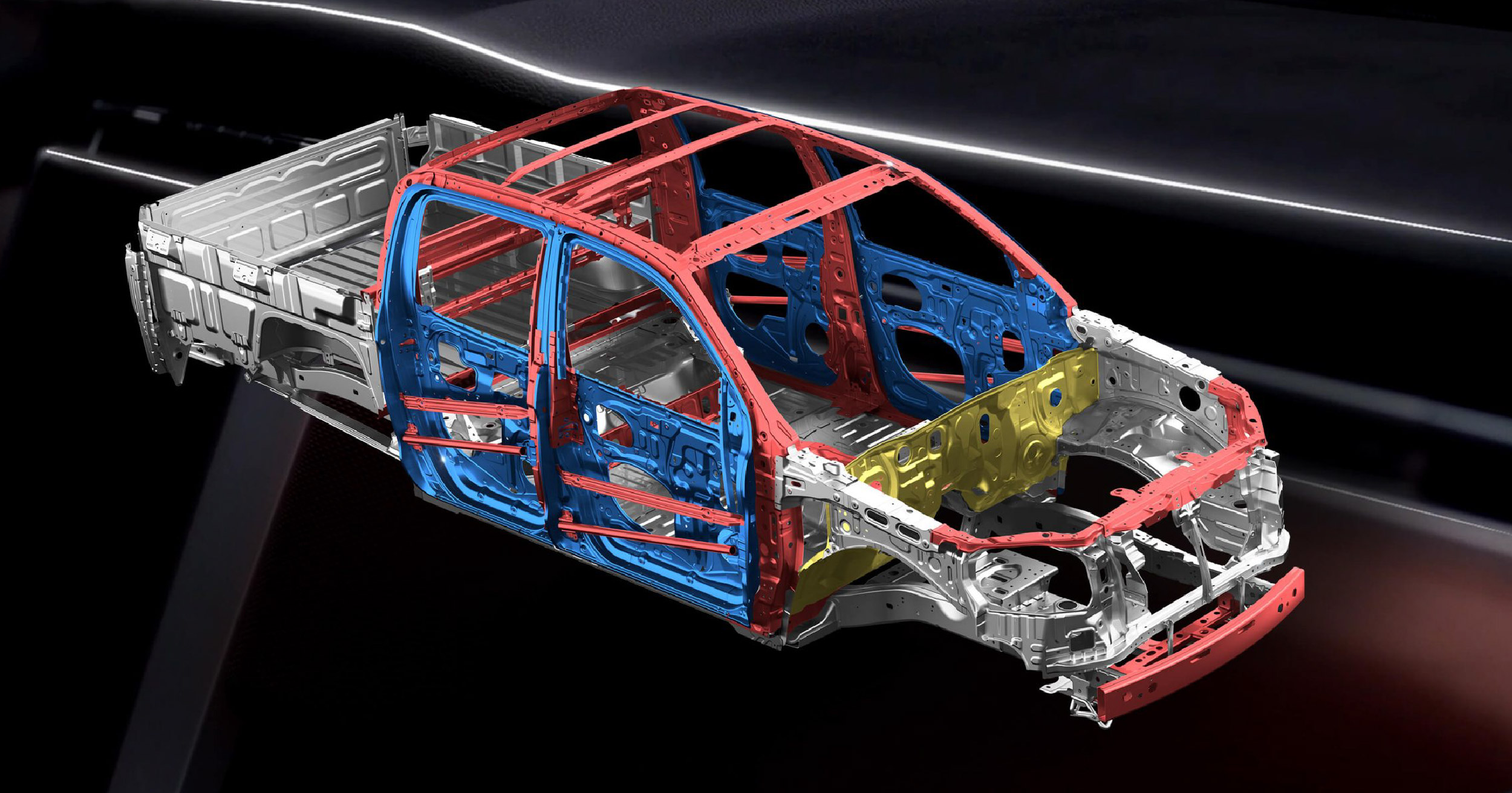 Detailed view of the JAC T8 pickup truck's chassis, showcasing the robust and colorful structural components including red, blue, and yellow sections.