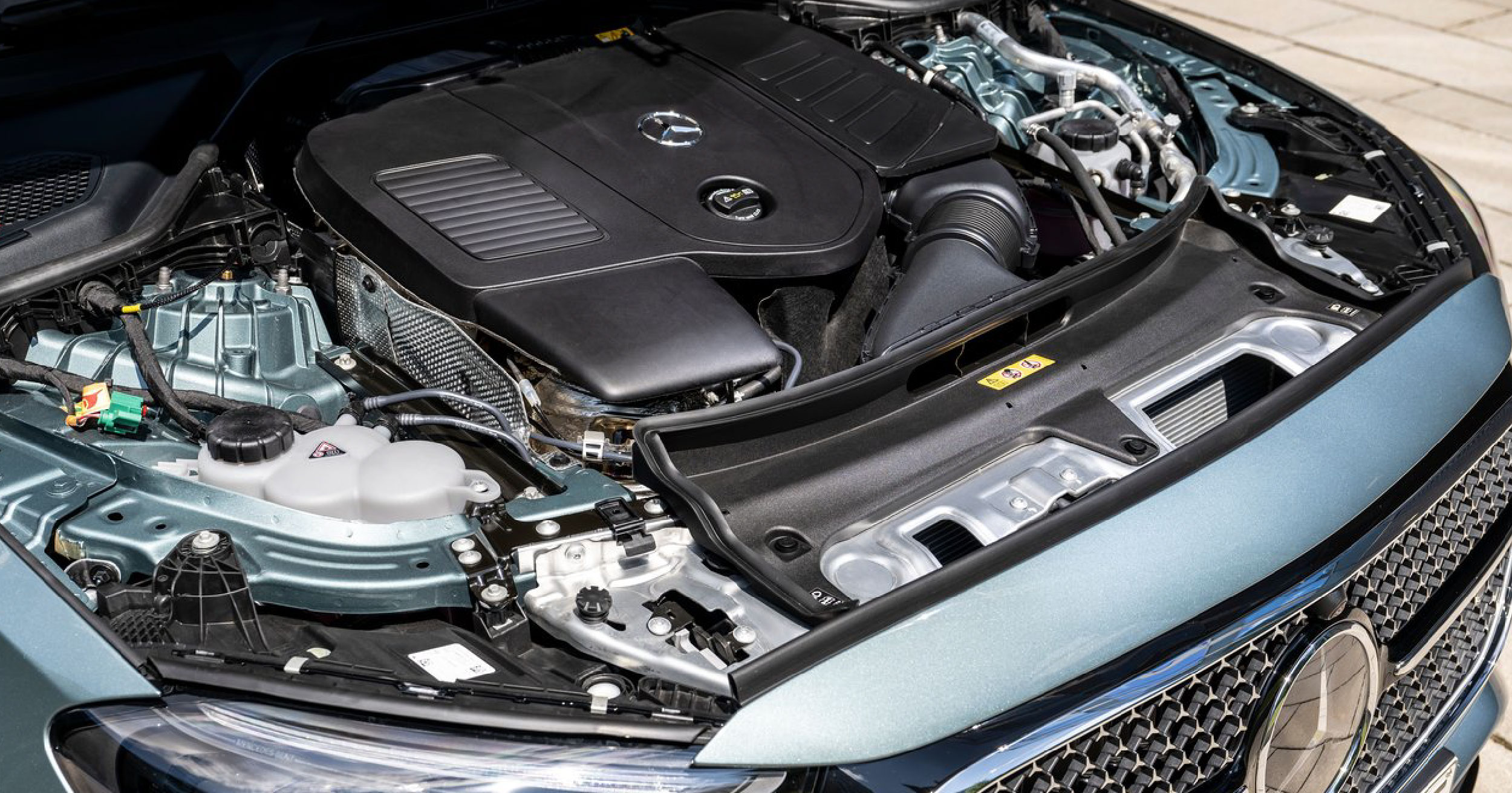 Close-up view of the engine compartment of the 2024 Mercedes-Benz E-Class, highlighting the powerful engine design, advanced components, and meticulous engineering.